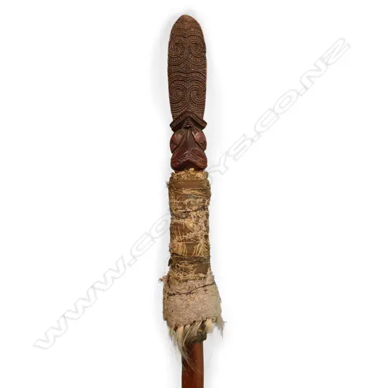 A 19thC or earlier Māori carved wooden taiaha with feather and dog hair wrap,